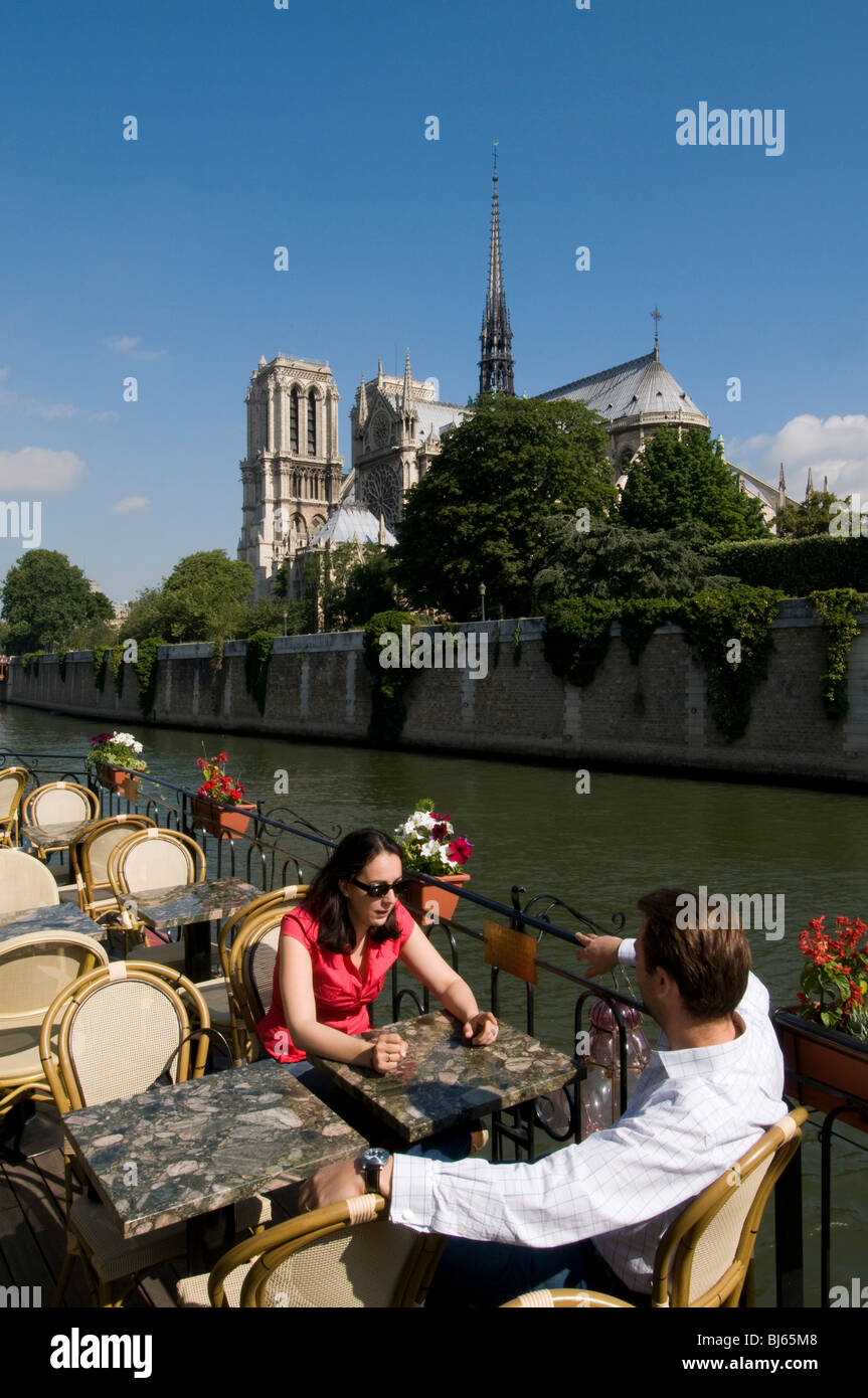 Café on Peniche on River Seine in front of Notre Dame Cathedral, Paris, France. Stock Photo
