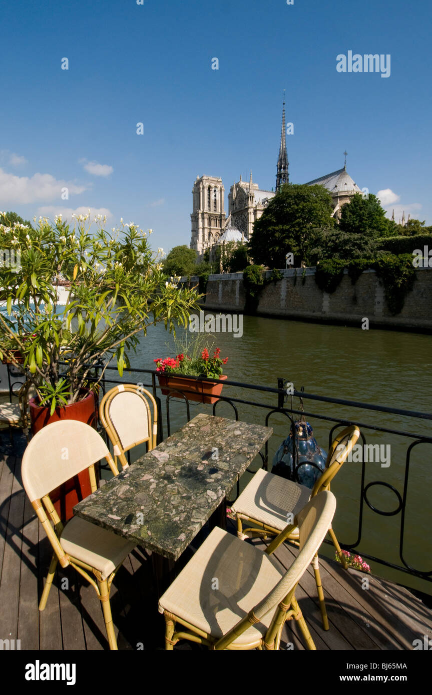 Café on Peniche on River Seine in front of Notre Dame Cathedral, Paris, France. Stock Photo