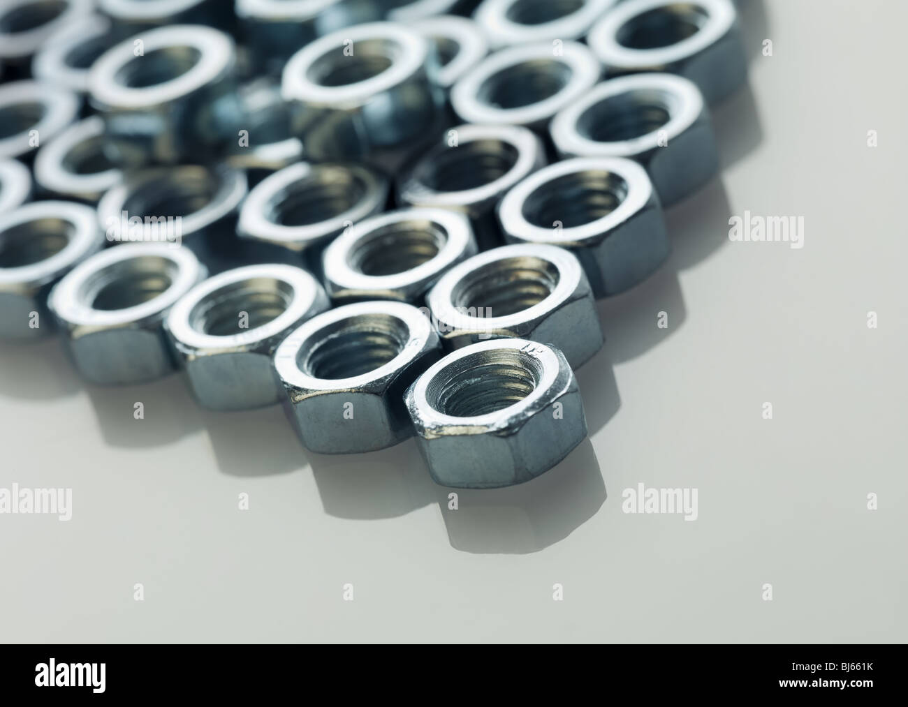 screw bolts on reflective white surface. Stock Photo