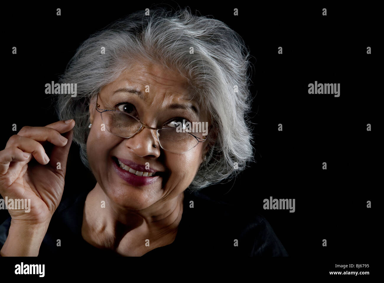 Old woman with glasses smiling Stock Photo