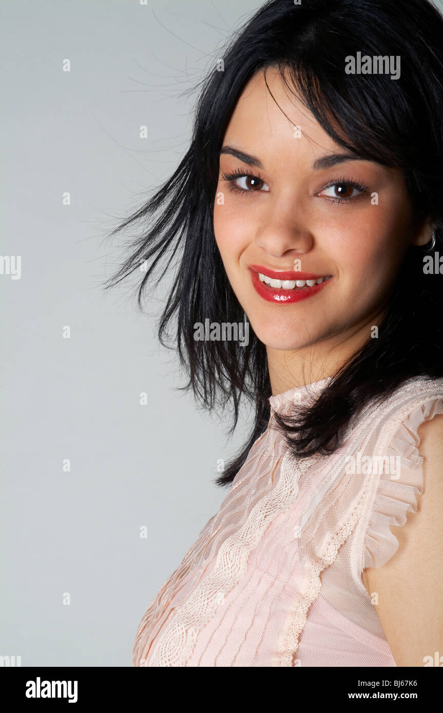 brunette, young, studio, background, pretty, smile, pink top, beauty, happy, satisfied Stock Photo