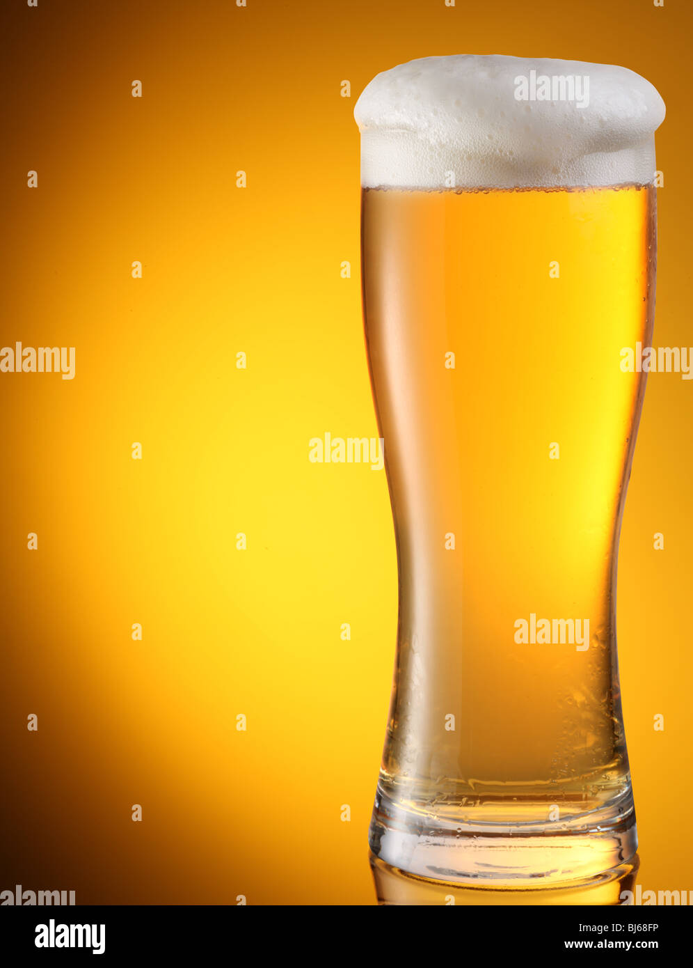glass of beer on a yellow background Stock Photo