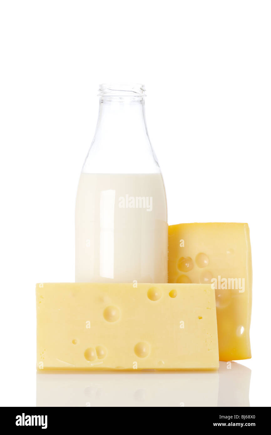 Slices of fresh cheese and milk bottle isolated on white background ...
