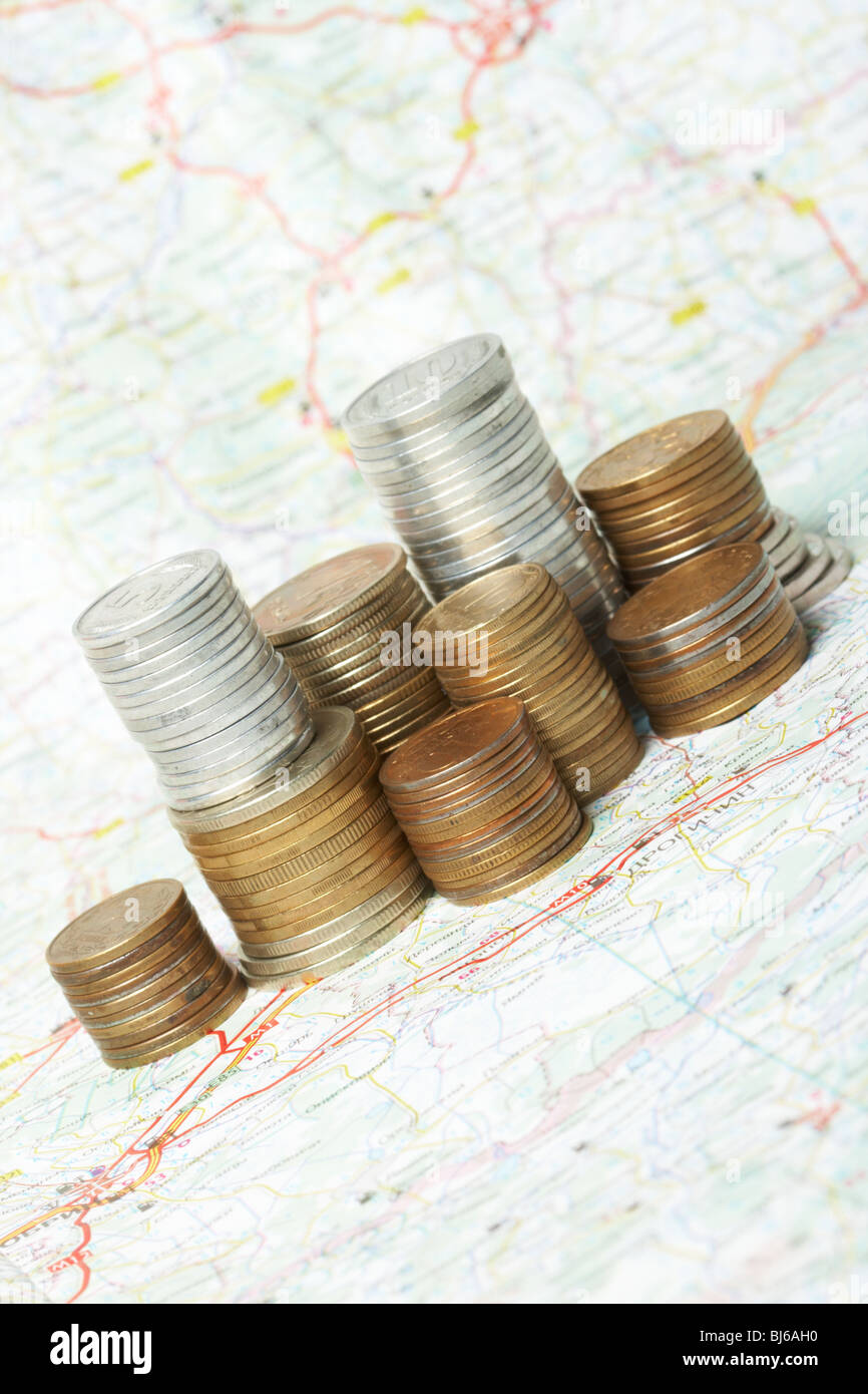 Coins lay on a map Stock Photo