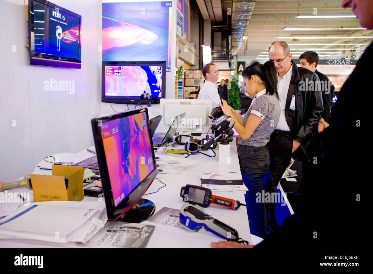 Paris, France,  Construction Equipment Trade Show, Salesman talking to client at Sustainability Trade Show, Holding  Infra-Red, Foire Exposition Stock Photo