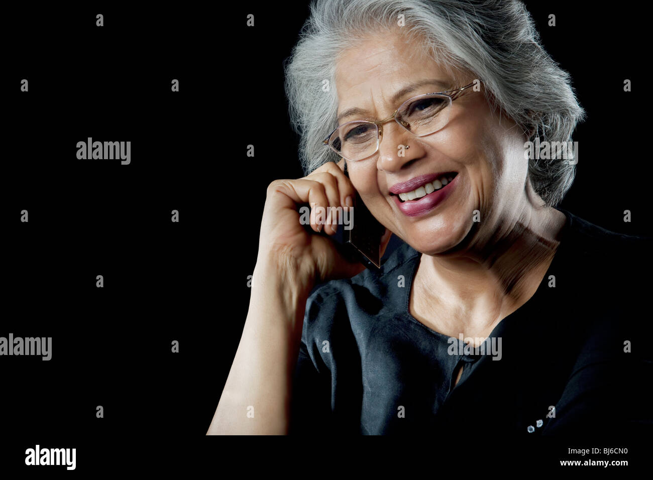 Old woman talking on a mobile phone Stock Photo