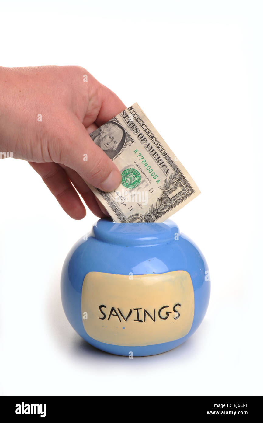 Hand placing a dollar note into a blue money box, the money box says