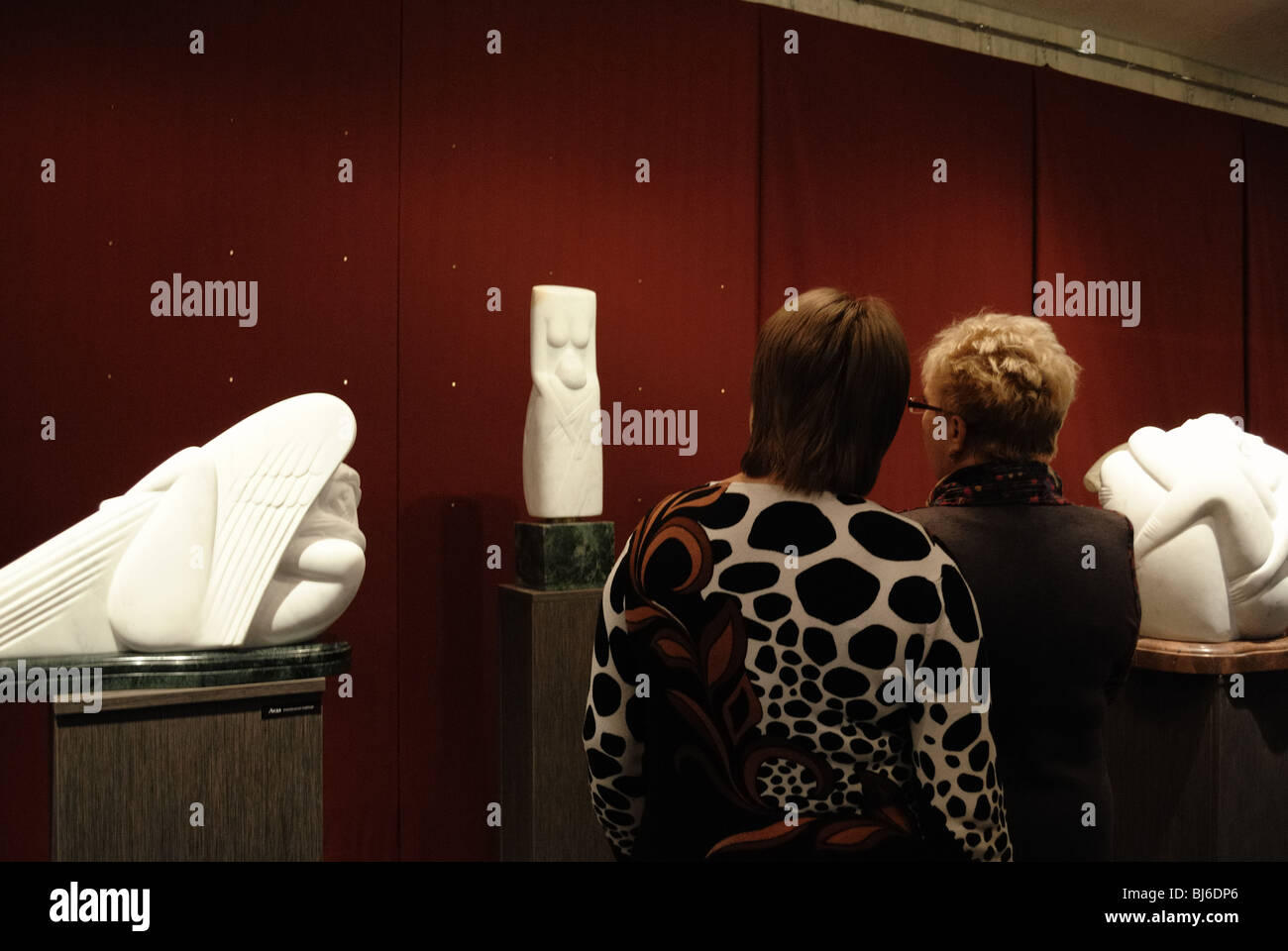 Visitors view sculptures displayed at a Great Sculpture Exhibition Stock Photo