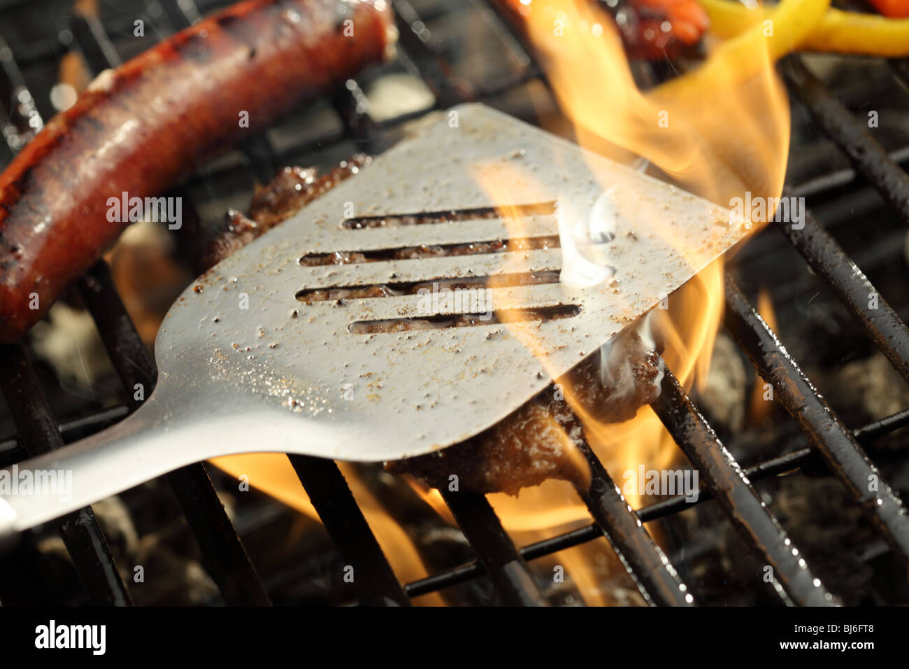 Barbecue grill with hamburger and sausage Stock Photo