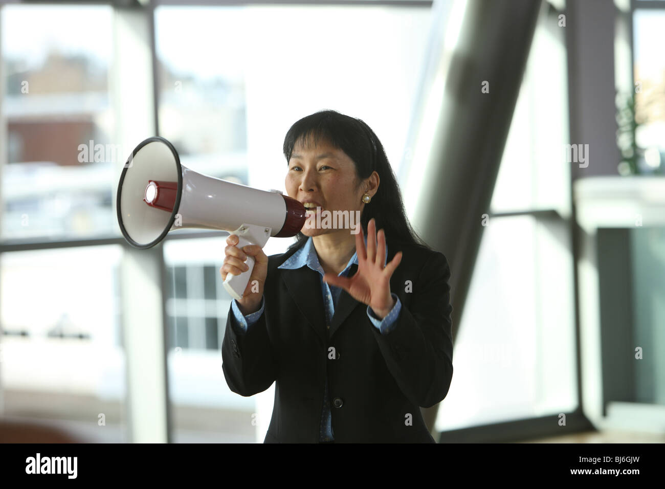 Businesswoman talking with megaphone Stock Photo