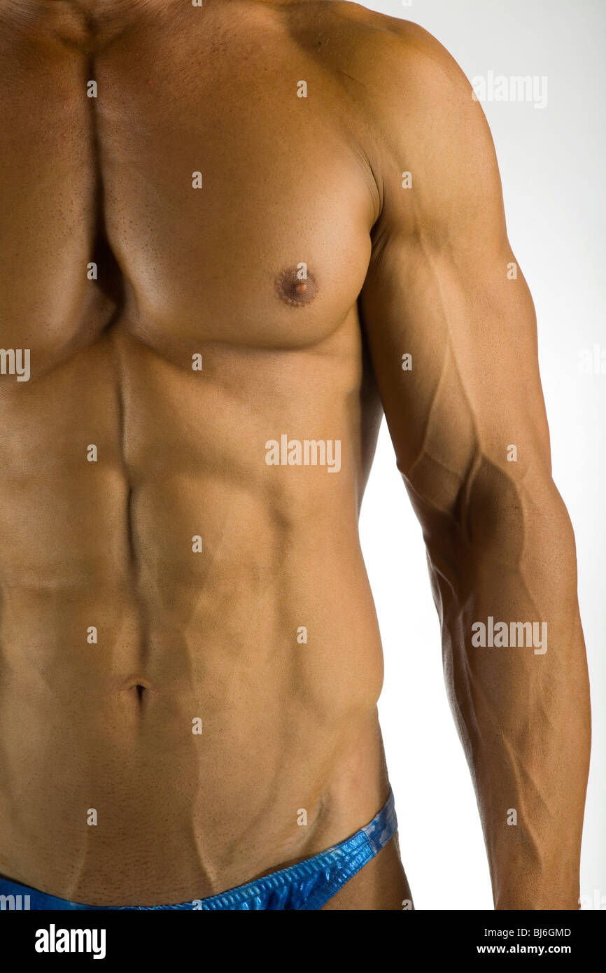 Man with muscular torso in trunks Stock Photo