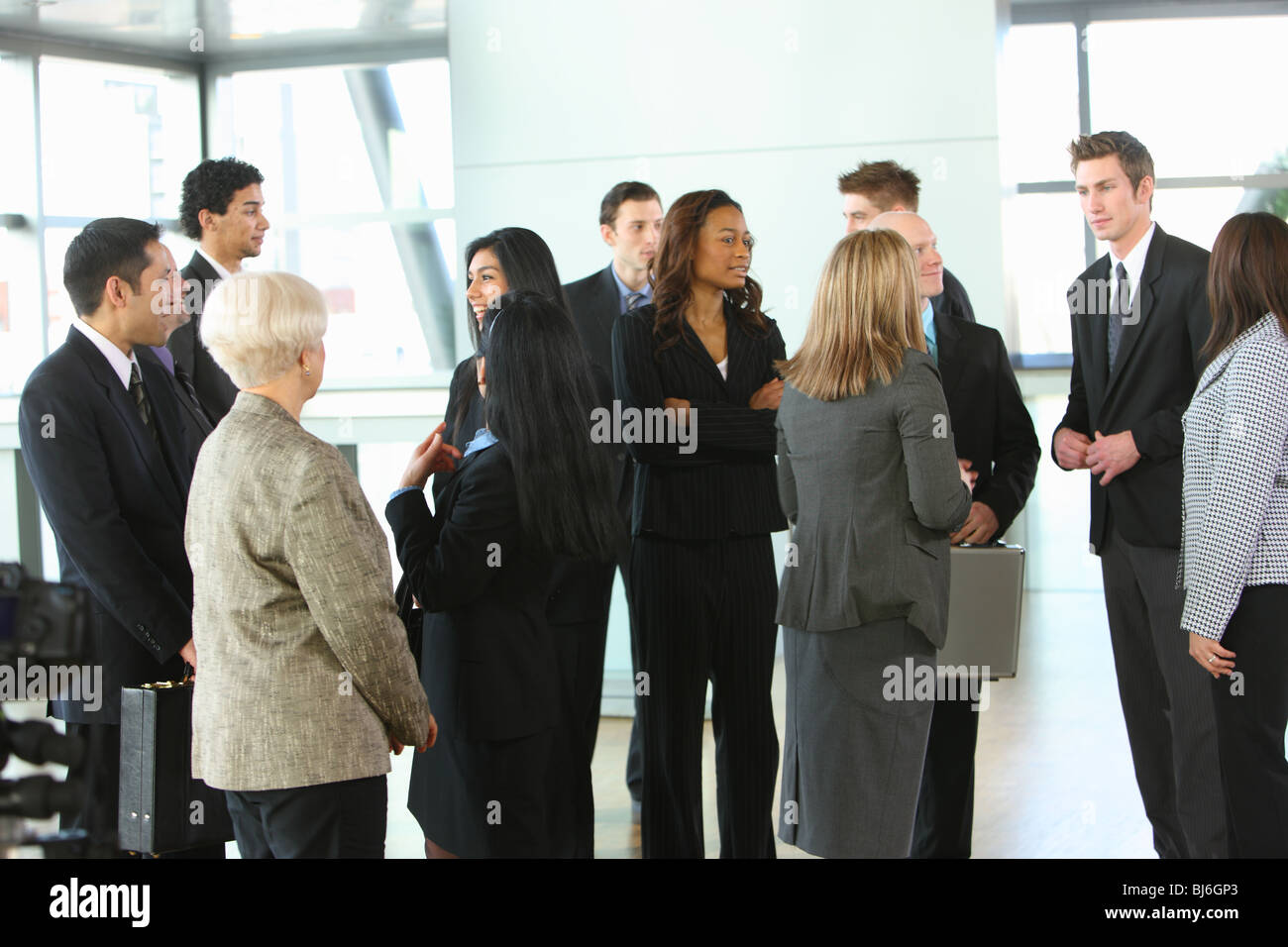 Crowd of businesspeople in lobby Stock Photo