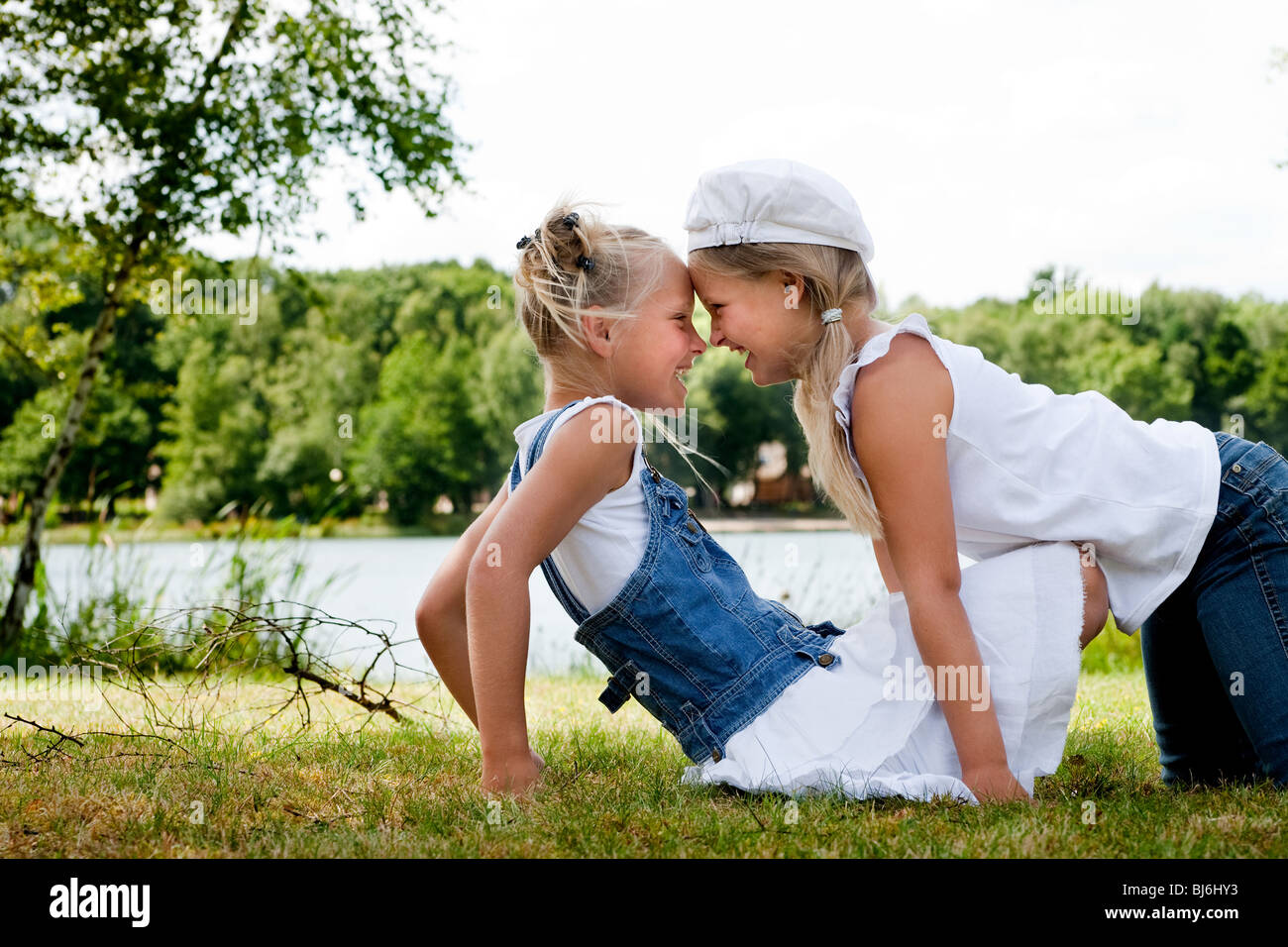 Two little girls in fresh colors in the park Stock Photo - Alamy