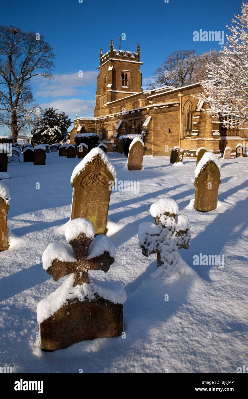Winter snow in the village churchyard in Slingsby in North Yorkshire in the United Kingdom Stock