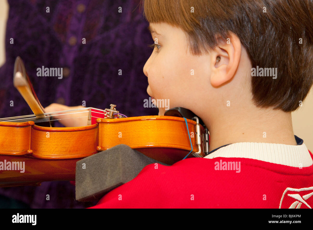 Boy age seven practicing violin at music lesson. St Paul Minnesota USA Stock Photo Alamy