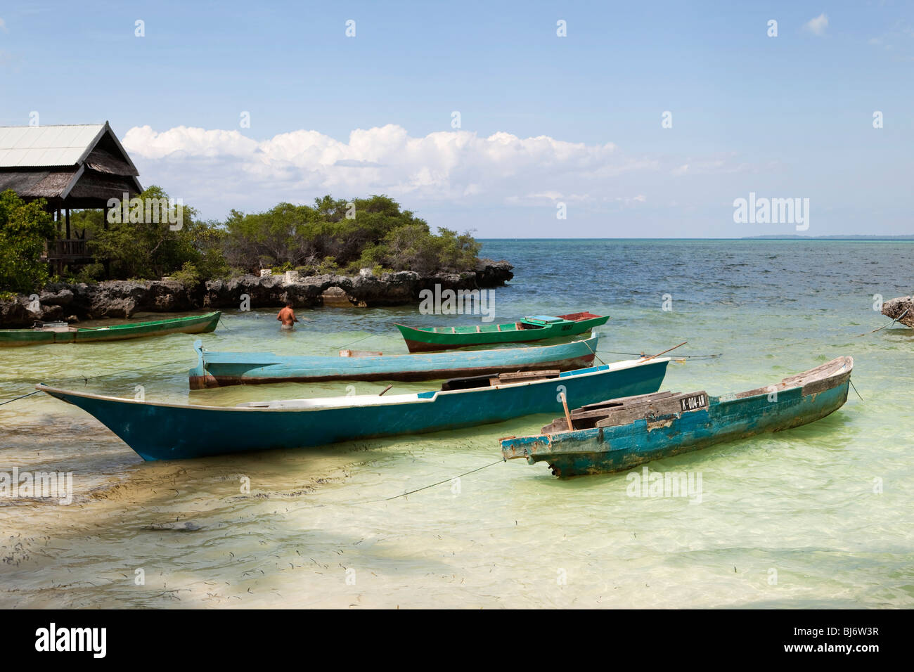 Indonesia, Sulawesi, Hoga Island, small dugout boats moored in small bay Stock Photo