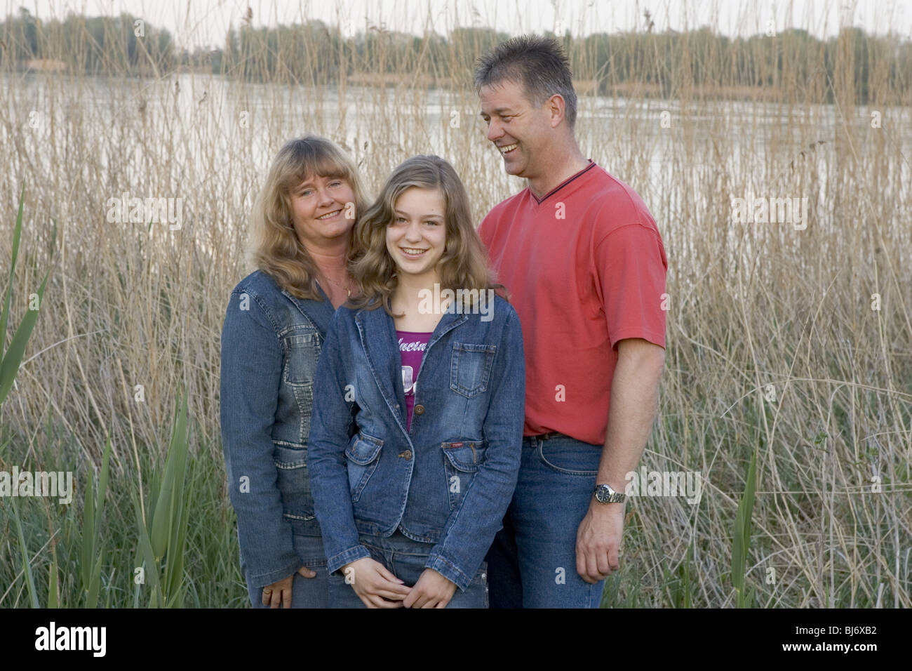 Happy family portrait outside in countryside. Stock Photo