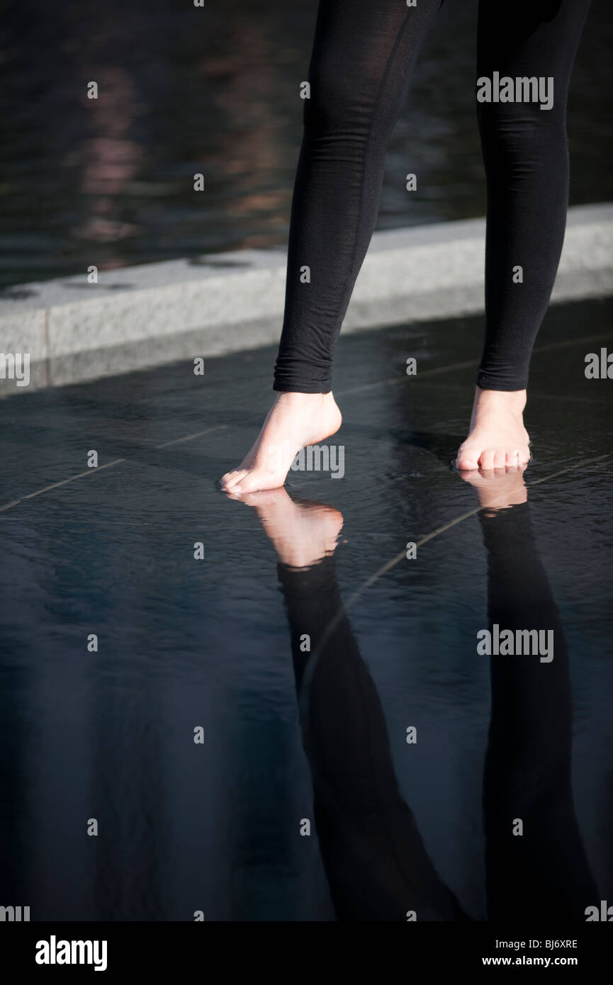 Female bare feet and leggings walking on water Stock Photo - Alamy
