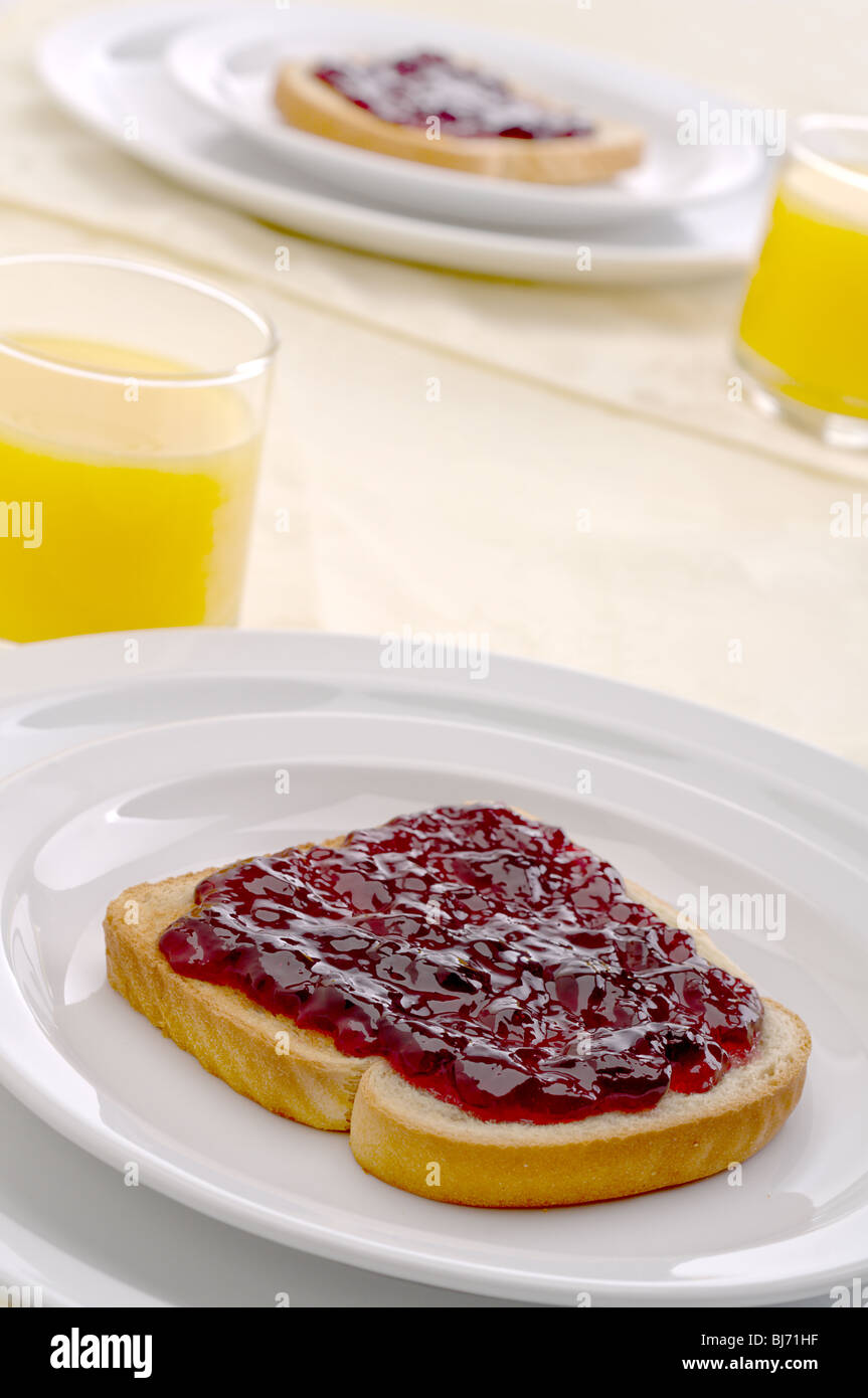 Morning breakfast with orange juice and jam or jelly on toast Stock Photo