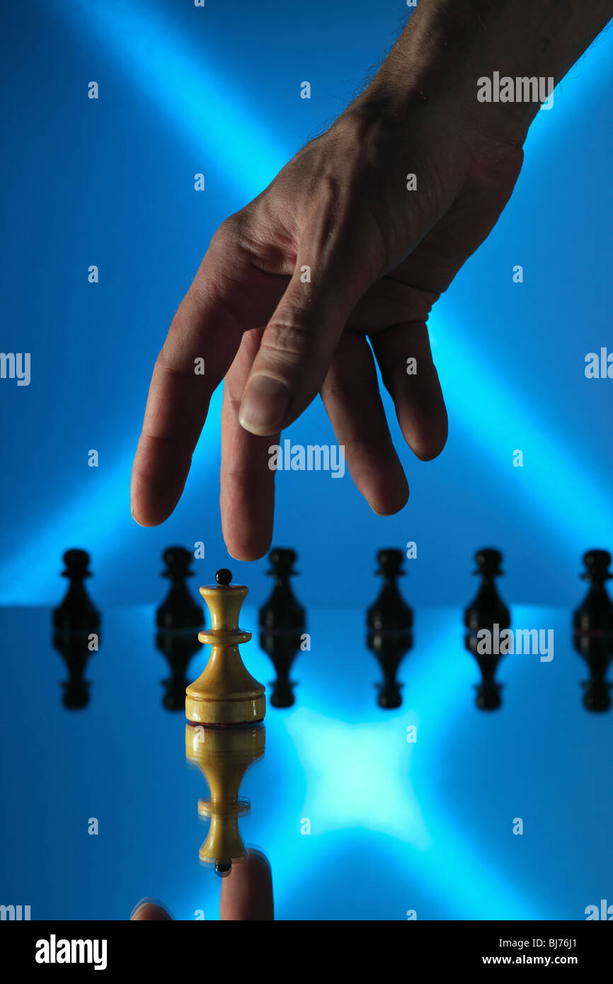 chess on a mirror table and hand Stock Photo
