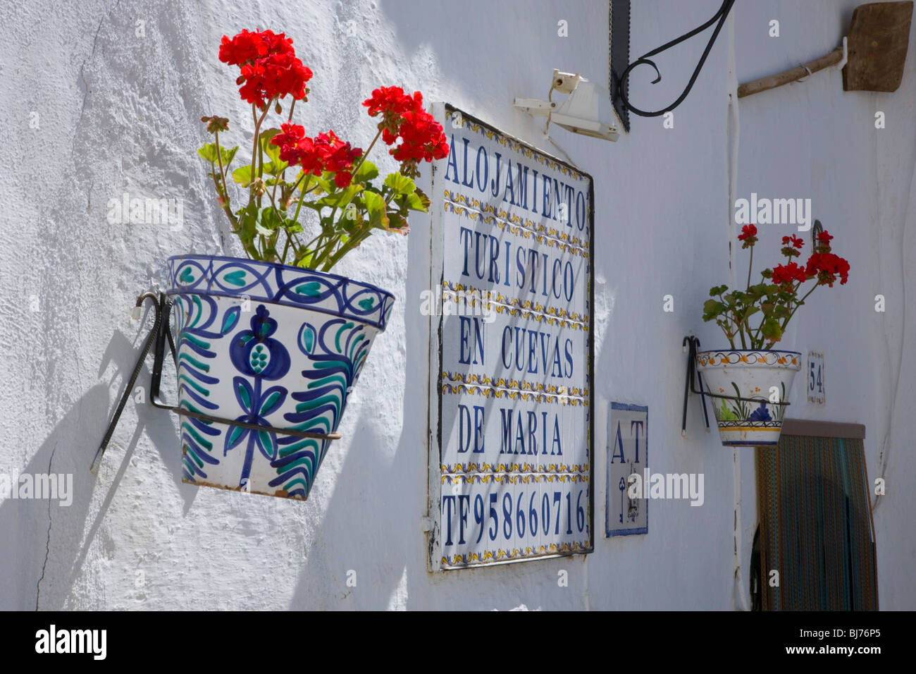 Guadix, Andalusia, Spain. Pot plant and sign advertising cave accommodation in the famous troglodyte district. Stock Photo