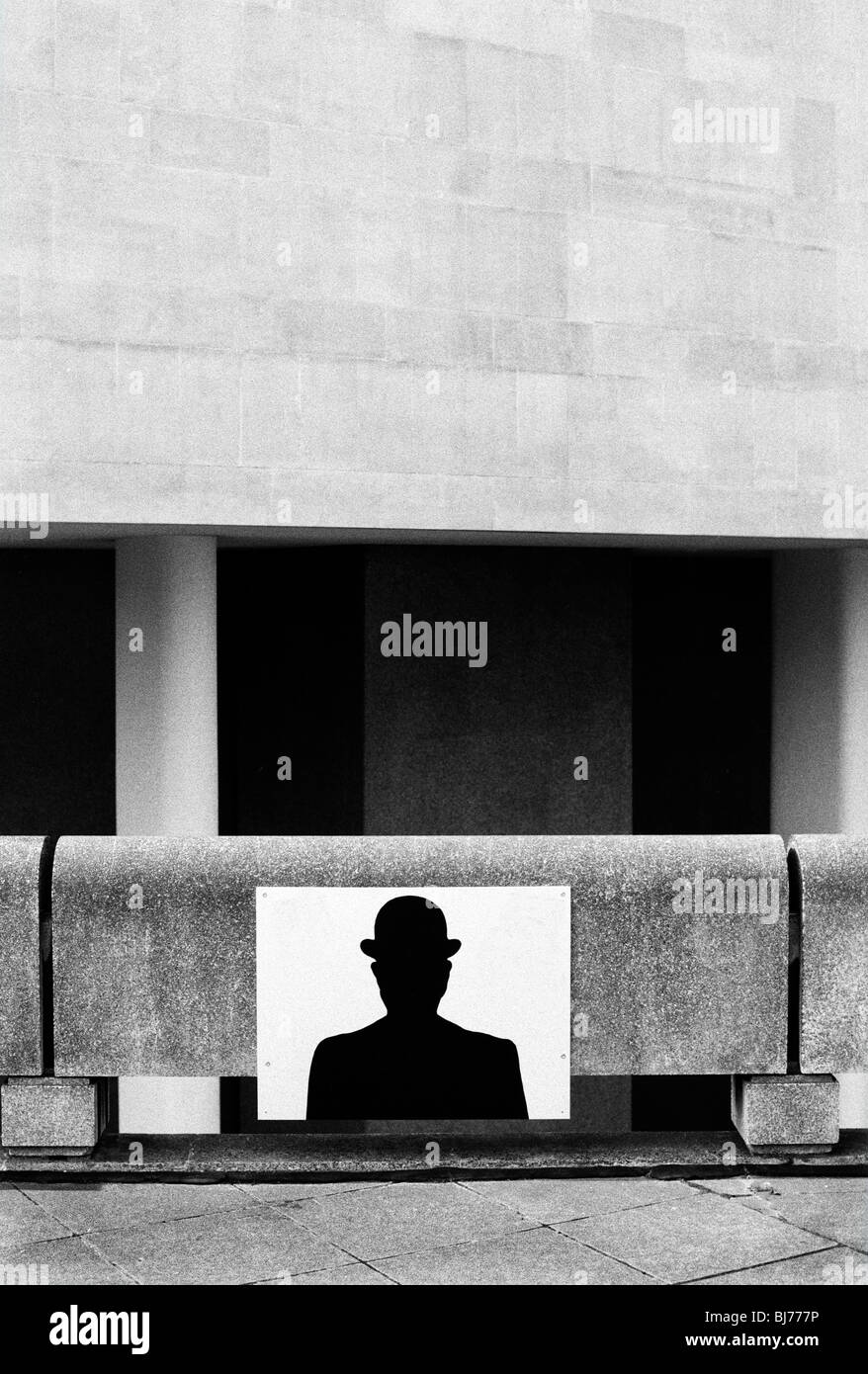 sign on wall with a silhouetted  of a man wearing a bowler hat Stock Photo