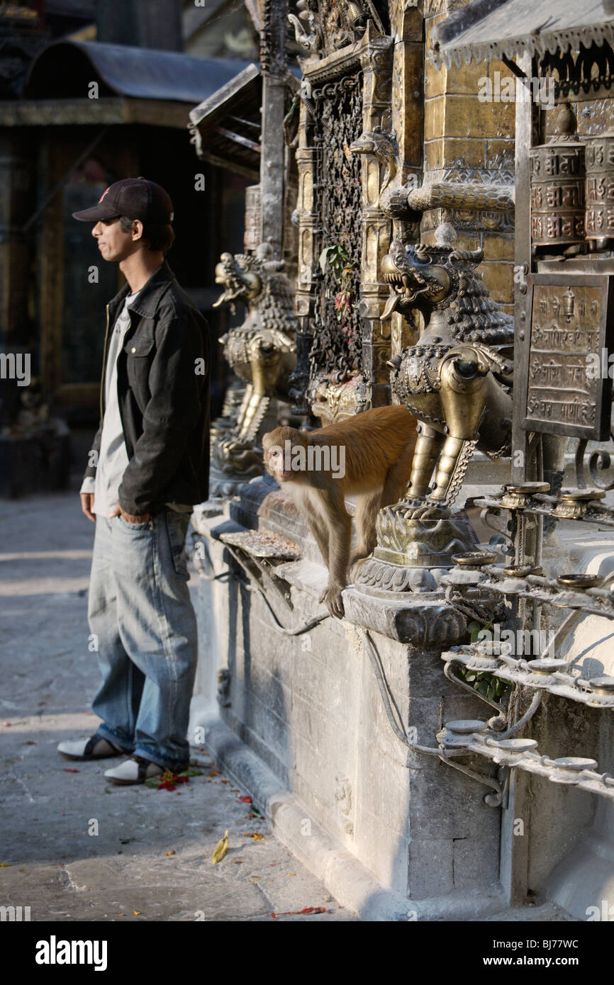 Tourist and monkey in Swayambhunath temple (Monkey temple), Kathmandu, Nepal. Stock Photo