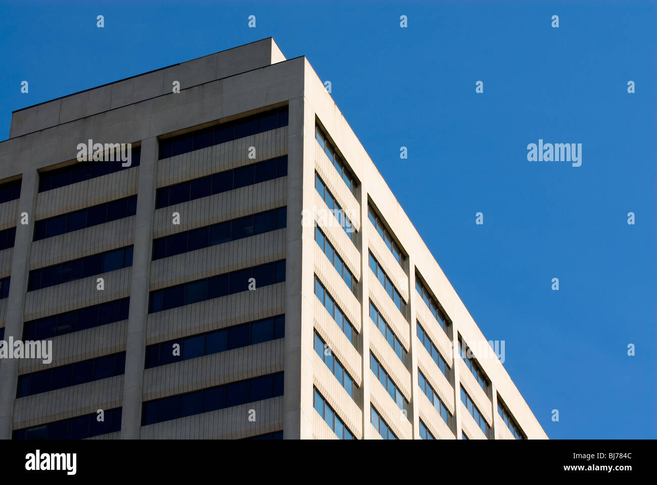 Large gray concrete office building with blue sky Stock Photo Alamy