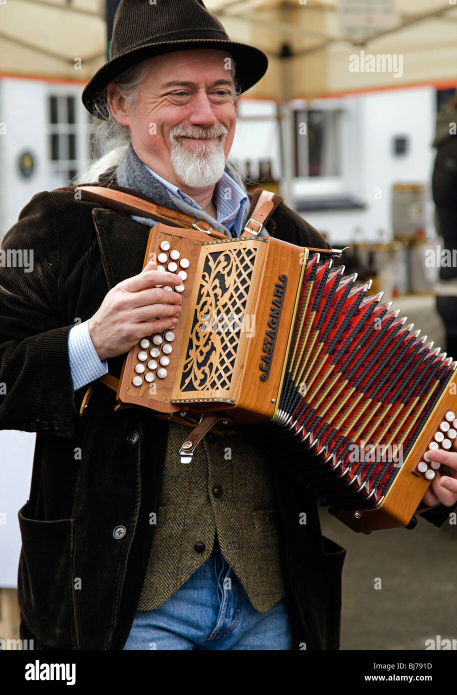 KINETON, WARKS; March 13:  Traditional folk musician plays the accordian at a farmer's market at Kineton, Wark, 13 March 2010 Stock Photo
