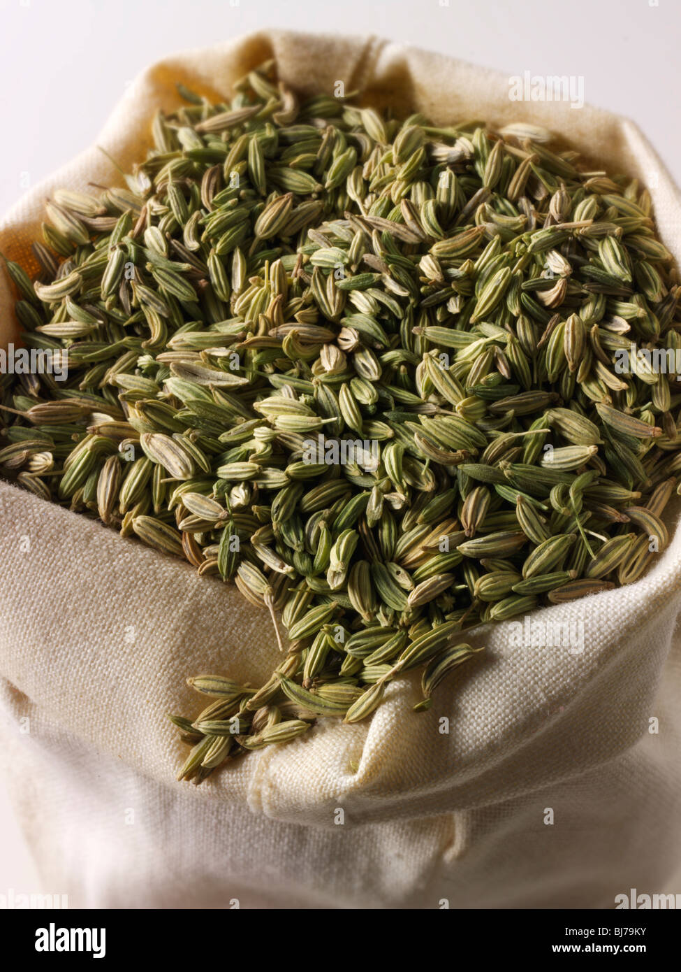 Whole fennel seeds  in a spice sack bag Stock Photo