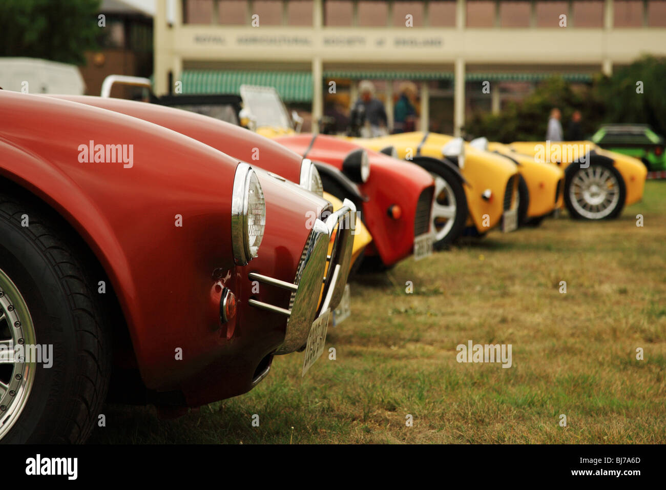 Red and yellow sports cars lined up at a car show in the UK Stock Photo