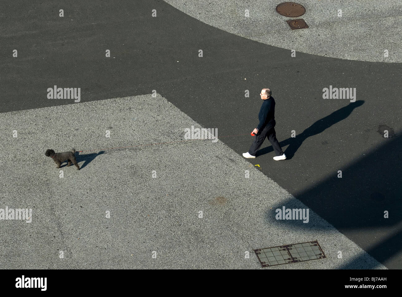 An old man walking a dog, Basel, Switzerland Stock Photo