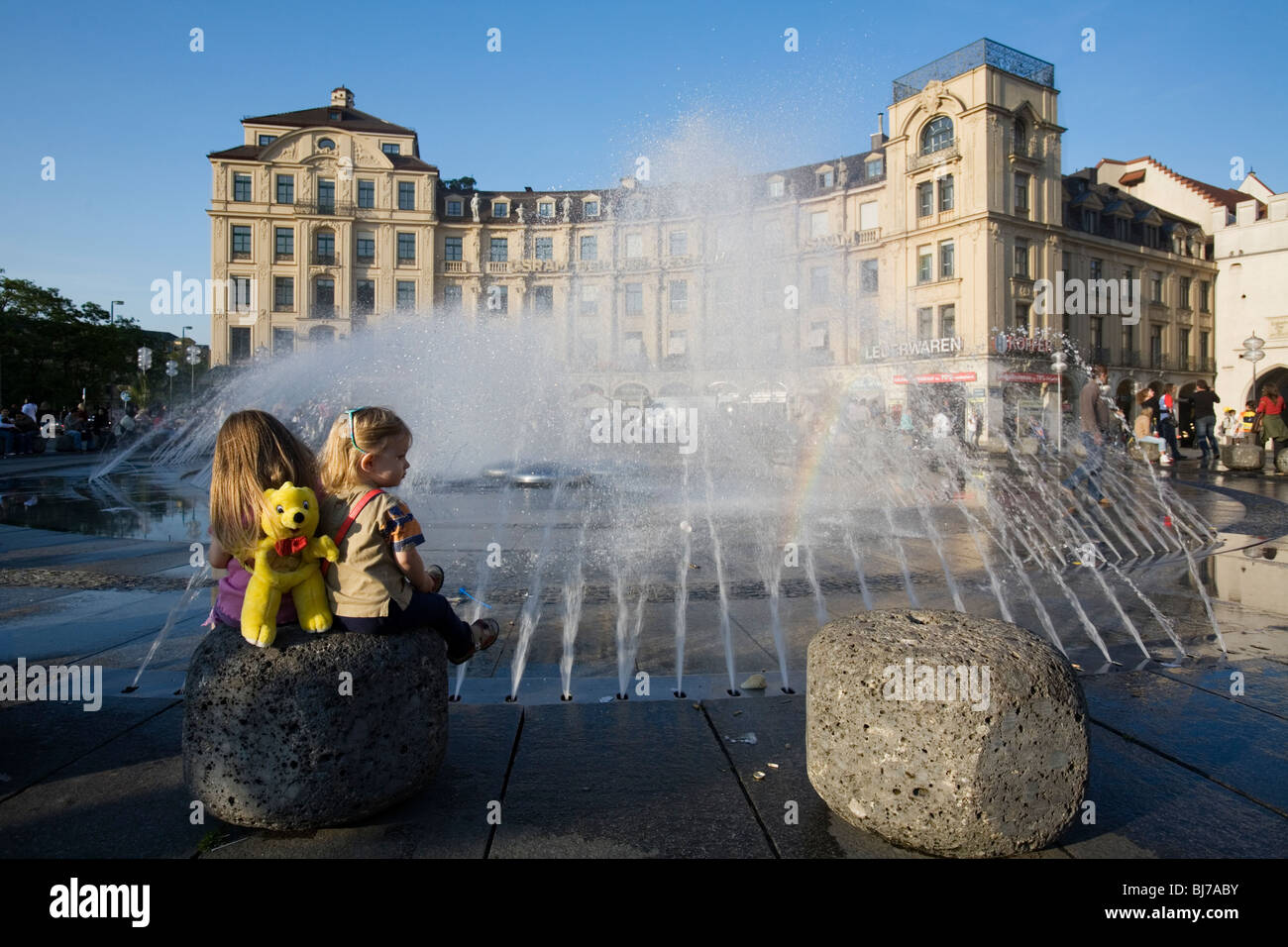 Two young girls in front of the Munich Marienplatz Fountain at Karlsplatz. Munich, Germany Stock Photo