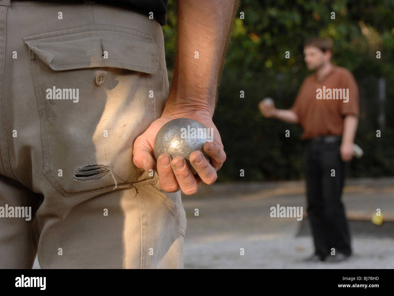 Boules player holding metal ball, Germany, Europe Stock Photo