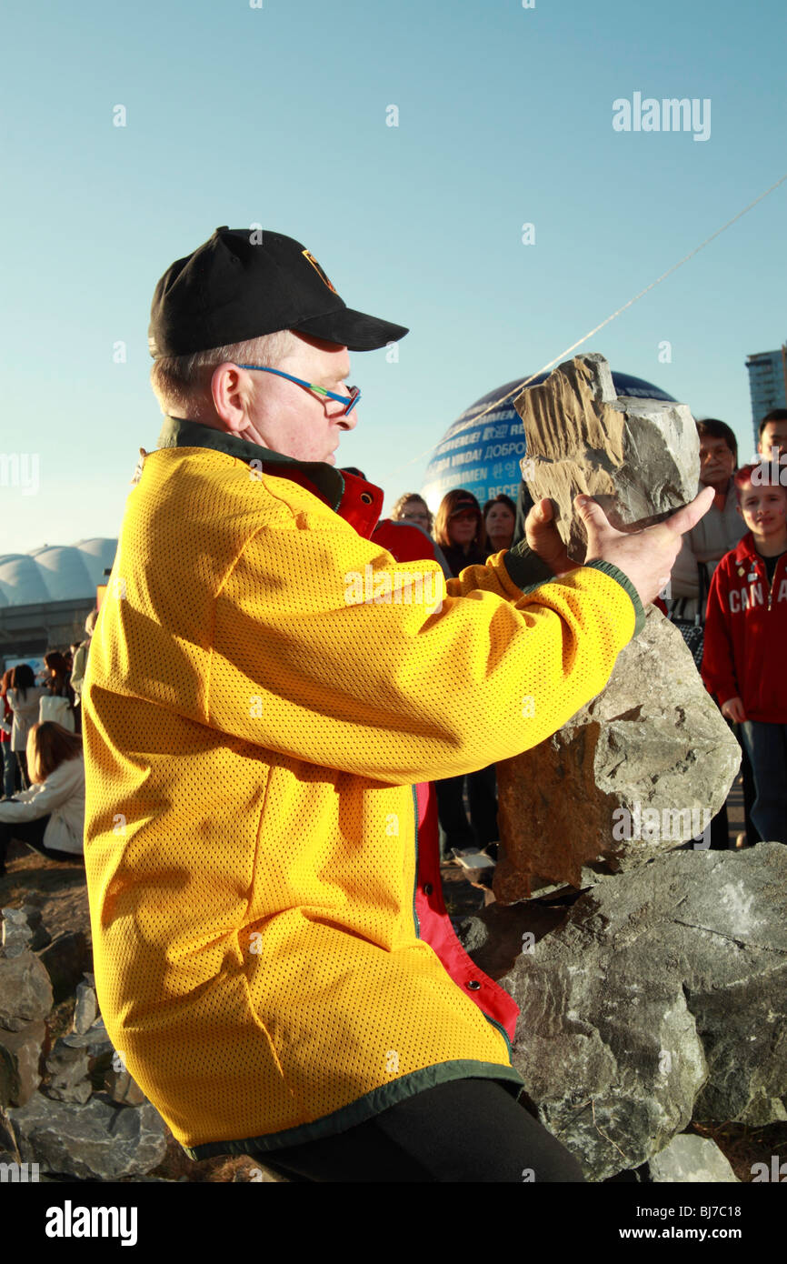 A man doing a demonstration of how to stack rocks using gravity and ...