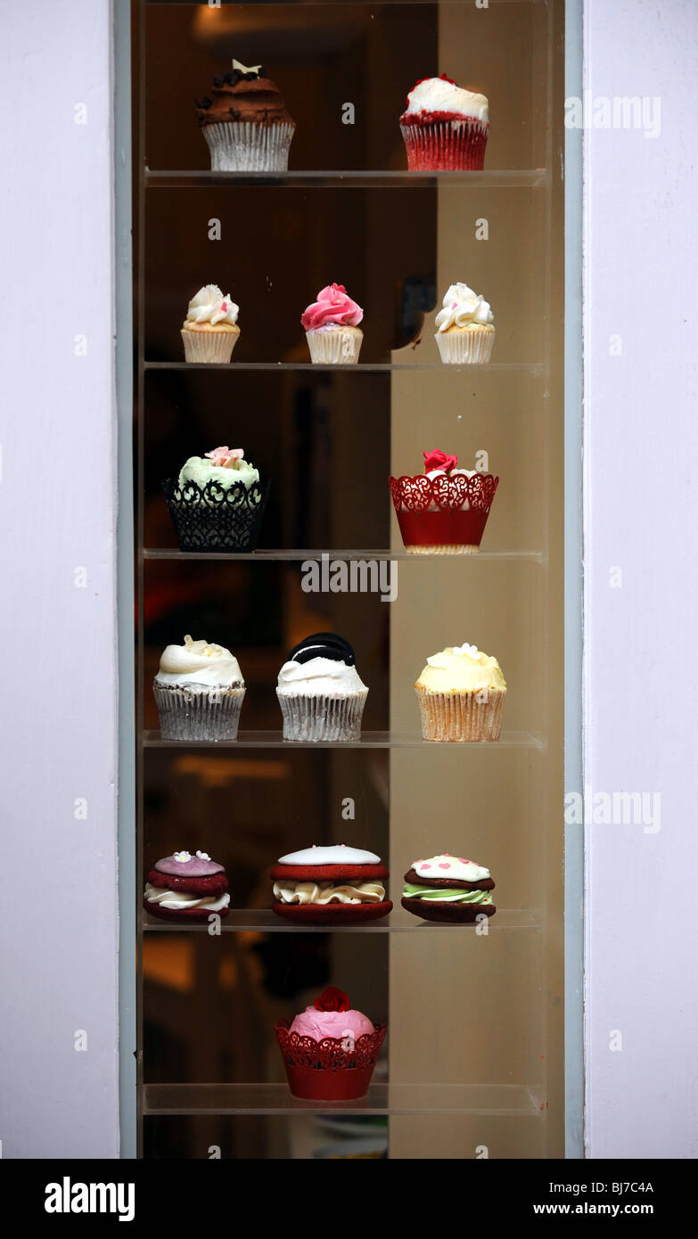 Cup cakes on display in a shop window in The Lanes Brighton UK Stock Photo