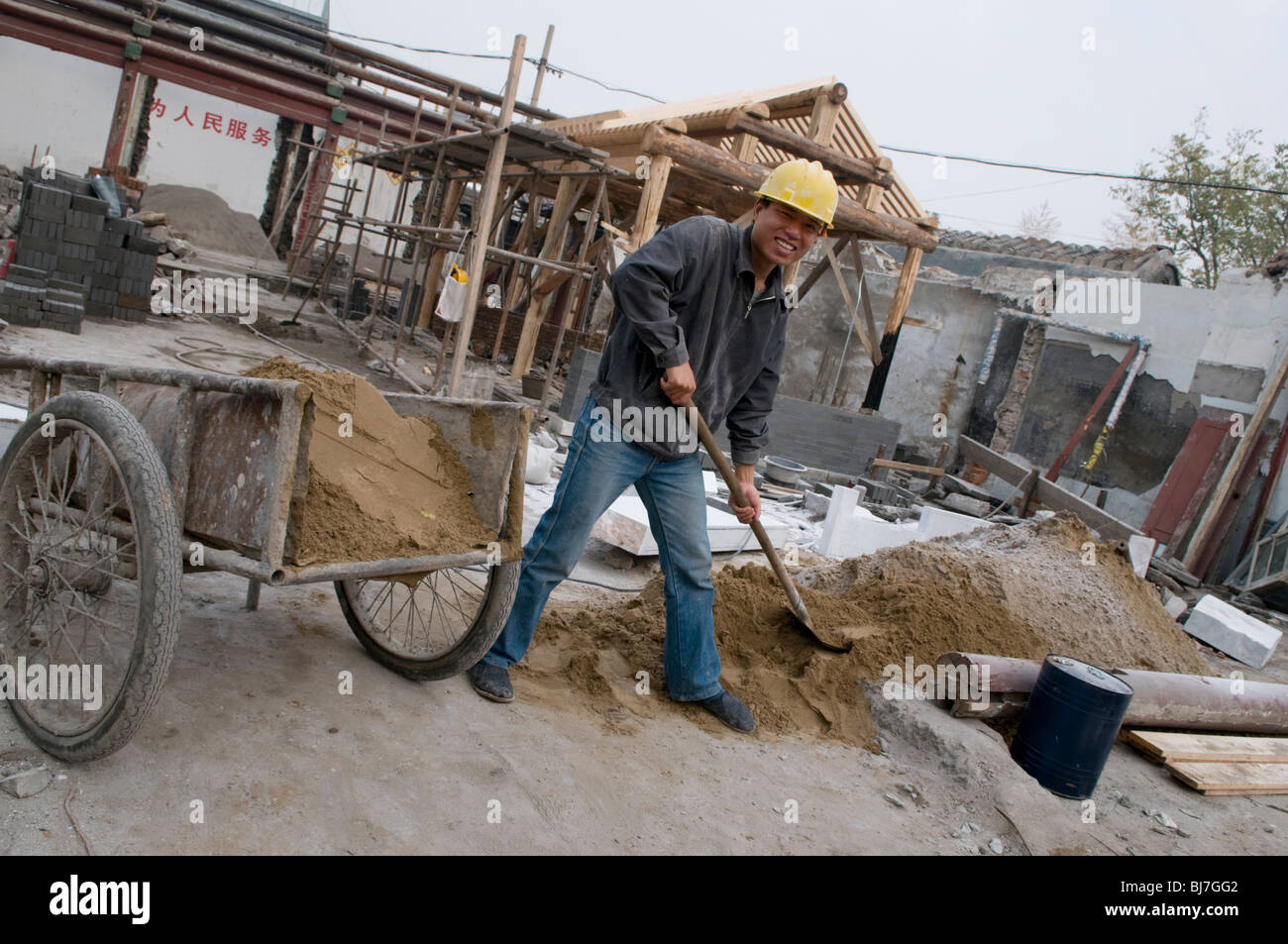 Construction labourer working on the restoration of a hutong in Beijing Stock Photo