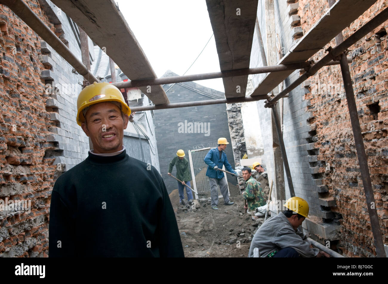 Construction labourer working on the restoration of a hutong in Beijingp Stock Photo
