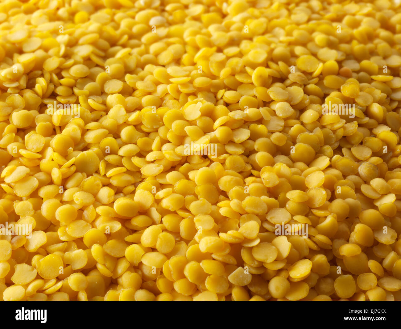 Whole dried yellow lentil beans - close up full frame top shot. Stock Photo