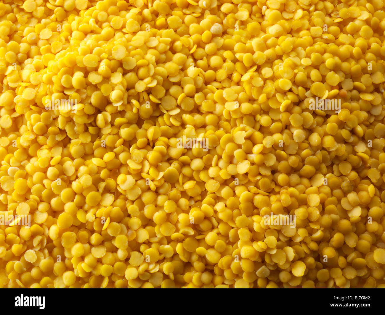 Whole dried yellow lentil beans - close up full frame top shot. Stock Photo
