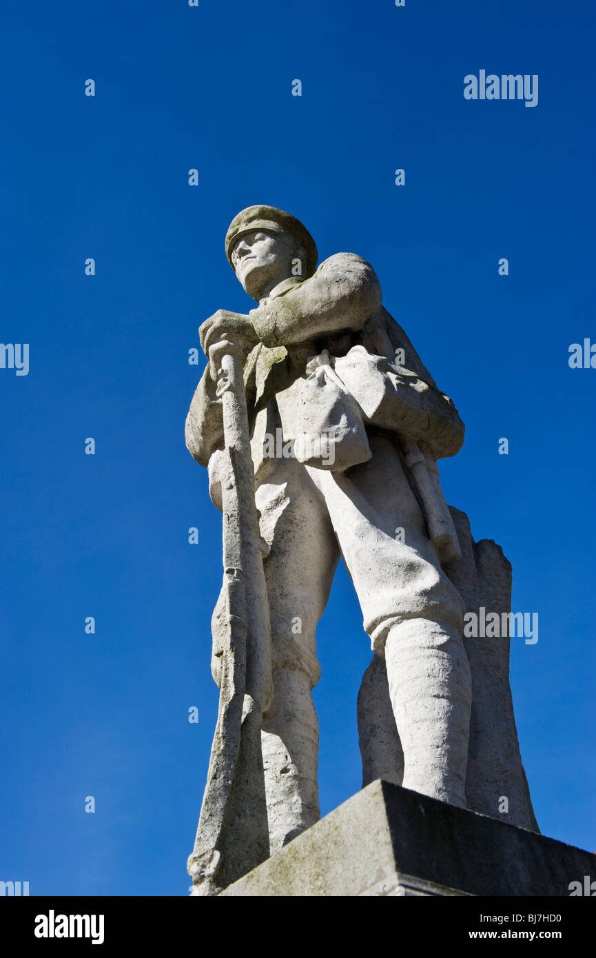 A statue of a first world war infantryman part of a war memorial in Chesham town Buckinghamshire UK against a clear blue sky. Stock Photo