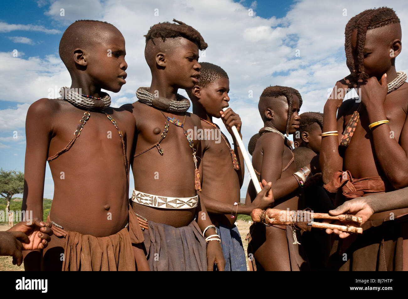 young himba teenagers (girls) children playing with doll Stock Photo