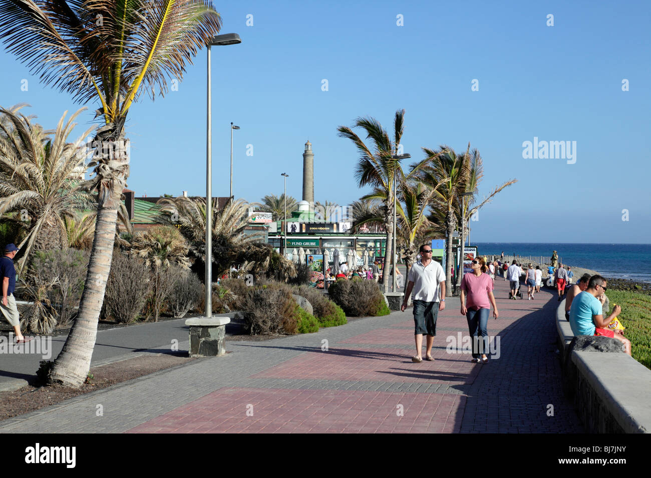 view of the promenade named lugar las meloneras with the maspalomas  lighthouse in the background gran canaria spain Stock Photo - Alamy