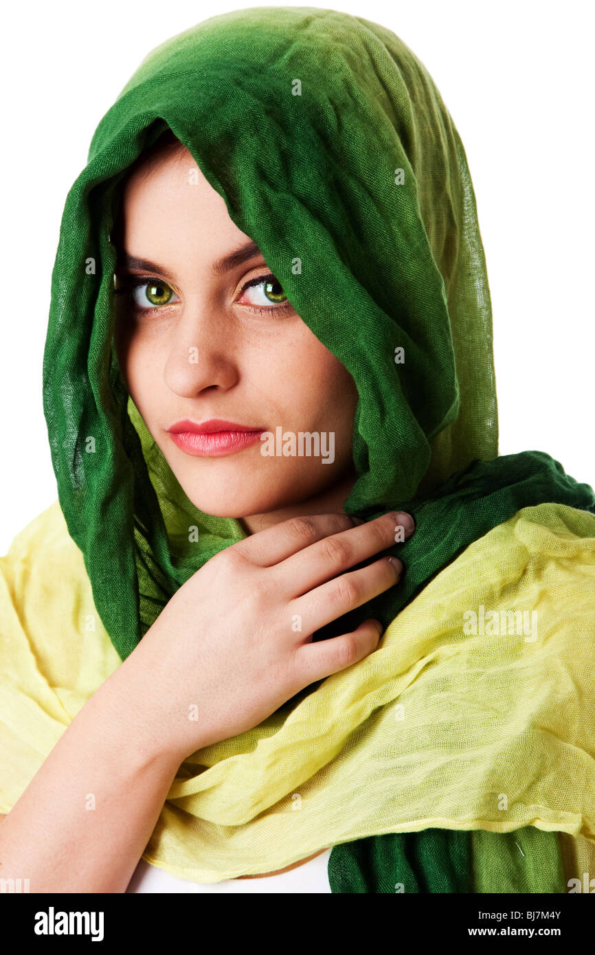 Portrait of mysterious beautiful Caucasian Middle Eastern woman face with green penetrating eyes and green fashion scarf wrapped Stock Photo