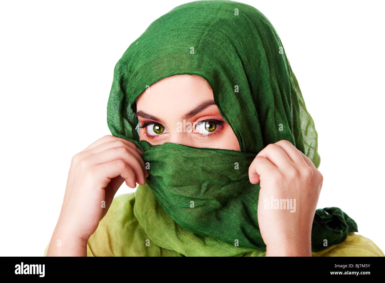 Portrait of mysterious beautiful Caucasian Hispanic Latina woman face with green penetrating eyes and holding green fashion. Stock Photo