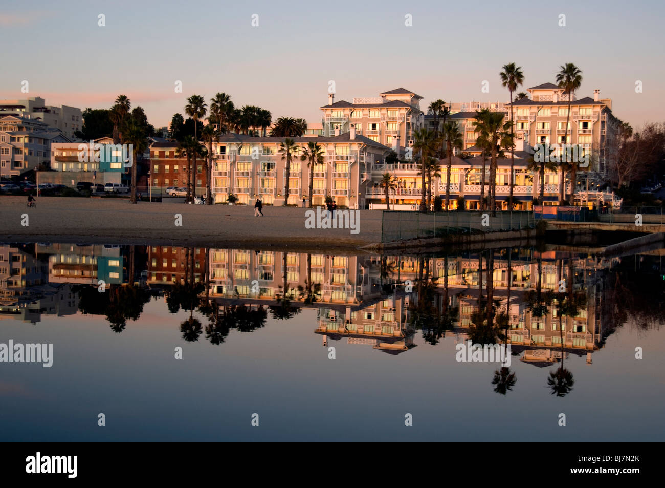 Ocean front hotels reflected in tide pool at beach in Santa Monica, CA, USA Stock Photo