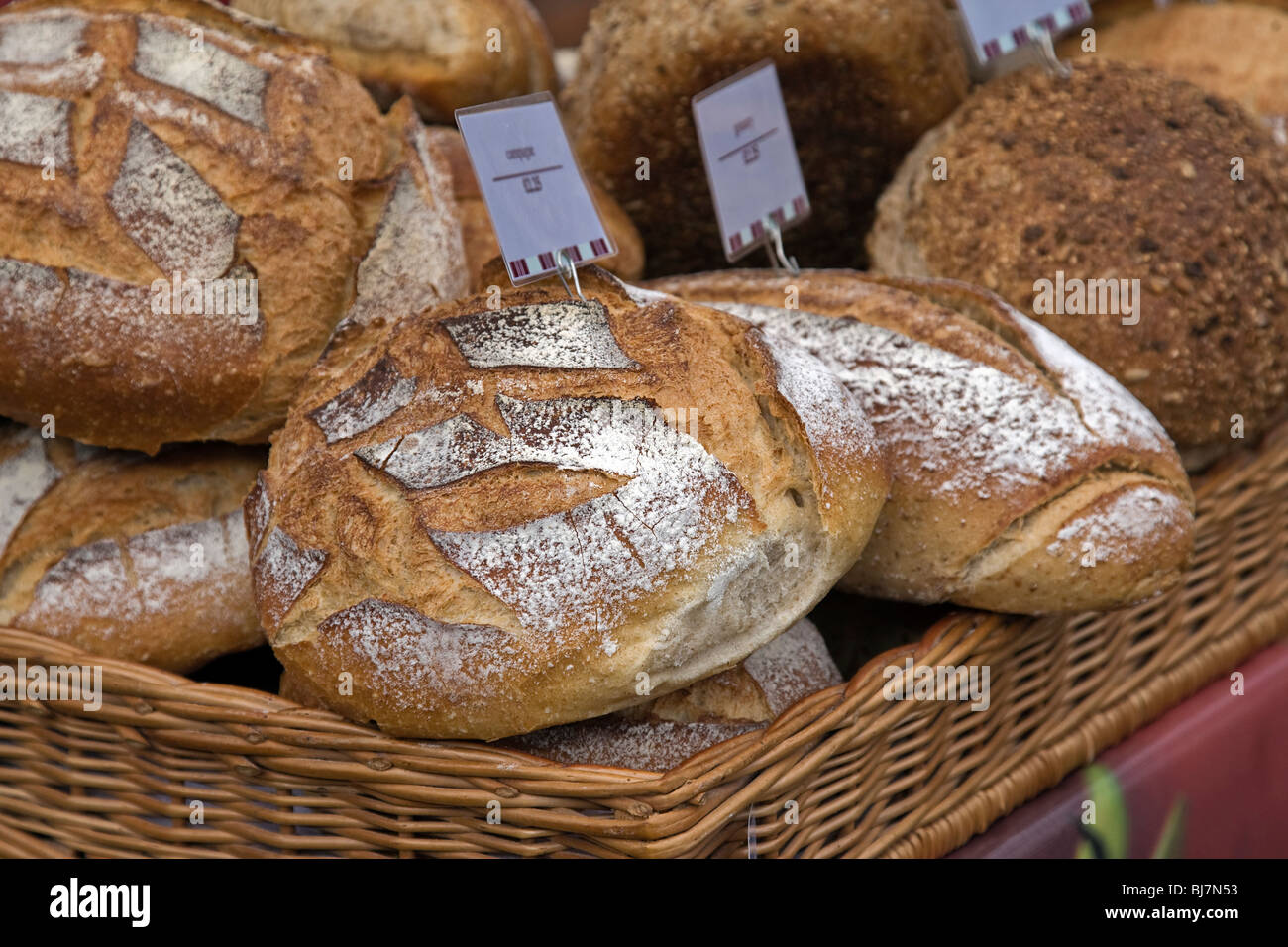 a basket of French bread on a market stall Stock Photo