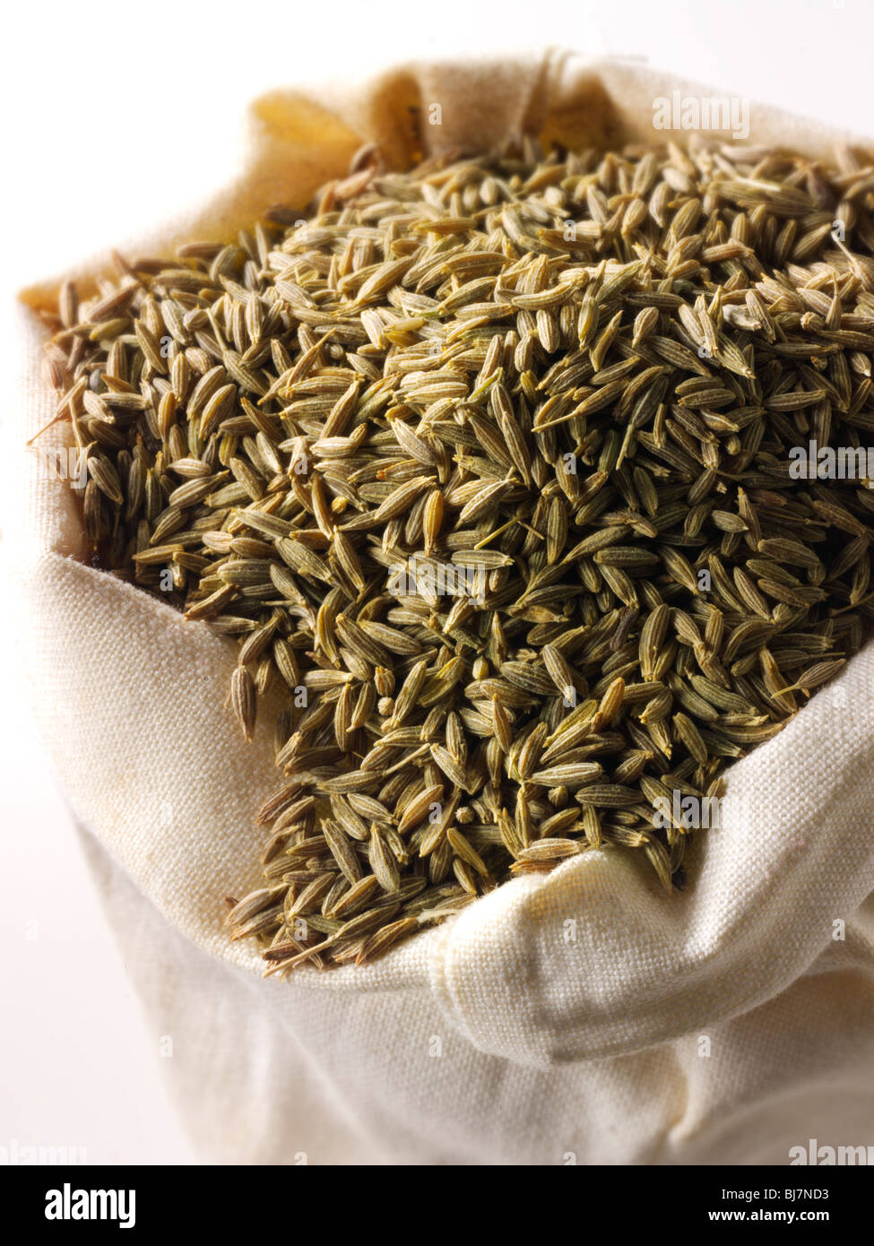 Whole Cumin Seeds  in a spice sack bag Stock Photo