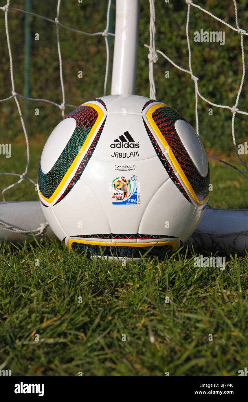 The FIFA 2010 World Cup replica match ball by Adidas, the Jabulani, in the corner of a football net. Stock Photo