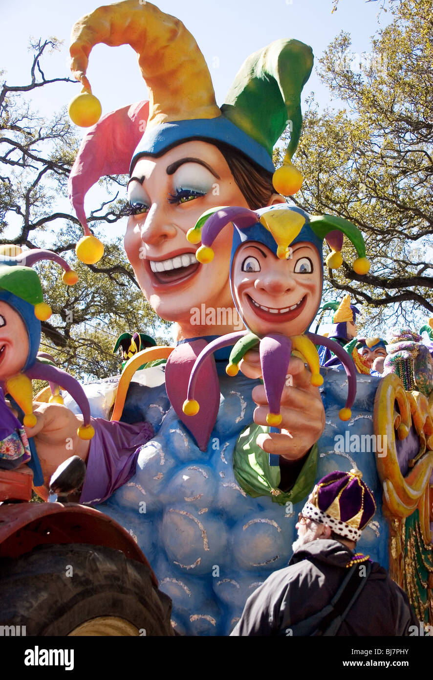 Mardi Gras reveler in a king's crown, watching the Rex parade on Mardi